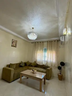 a living room with a couch and a table at Home louah in Fès