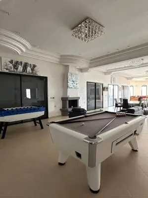 a large room with a pool table in it at Super belle villa avec piscine in Fès