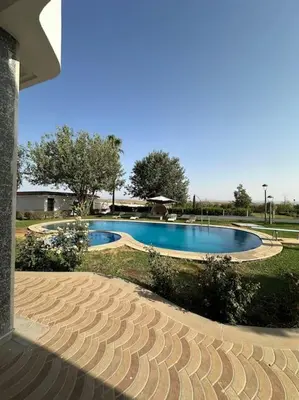 a swimming pool in the middle of a yard at Super belle villa avec piscine in Fès