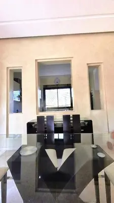 a dining room with a table and chairs and a window at Villa Belle vue - with a private & Heated pool in Marrakech
