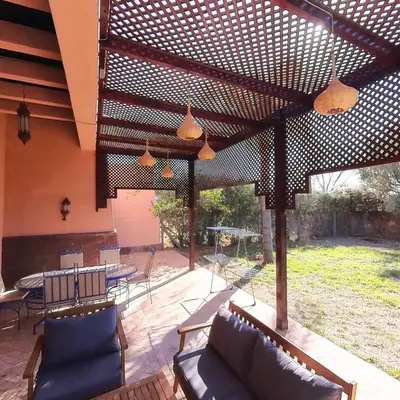 a patio with couches and chairs and a table at Villa Belle vue - with a private & Heated pool in Marrakech