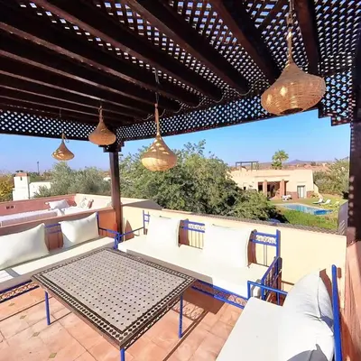 a patio with white couches and a table at Villa Belle vue - with a private & Heated pool in Marrakech