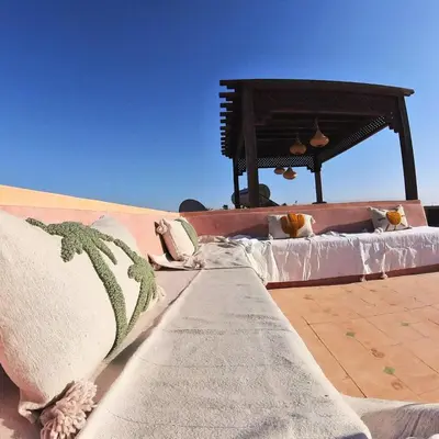 a bed with pillows sitting on top of a building at Villa Belle vue - with a private & Heated pool in Marrakech