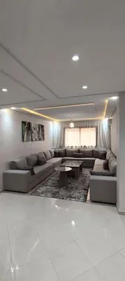 a large living room with couches and a table at APPART-HOTEL La MAISON ATTAWBA 1 in Beni Mellal