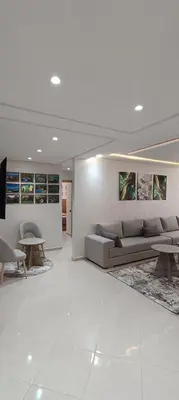 a living room with a couch and a table at APPART-HOTEL La MAISON ATTAWBA 1 in Beni Mellal