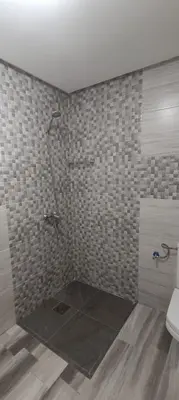 a bathroom with a shower and a toilet at APPART-HOTEL La MAISON ATTAWBA 1 in Beni Mellal