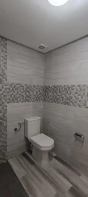 a bathroom with a white toilet in a room at APPART-HOTEL La MAISON ATTAWBA 1 in Beni Mellal