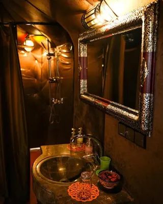 a bathroom with a sink and a mirror at Aurum Dunes Luxury Camp in Merzouga