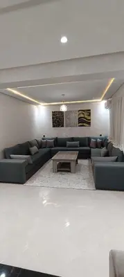 a living room with a couch and a coffee table at APPART-HOTEL La MAISON ATTAWBA 2 in Beni Mellal