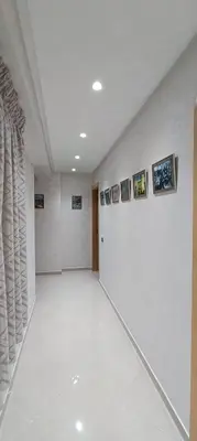 a white room with pictures on the wall at APPART-HOTEL La MAISON ATTAWBA 2 in Beni Mellal