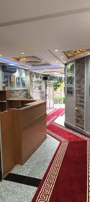 a lobby with a reception desk and a red carpet at APPART-HOTEL La MAISON ATTAWBA 2 in Beni Mellal