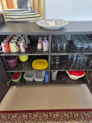 a shelf filled with dishes and other dishes at Villa des Oliviers MEKNES in Meknès