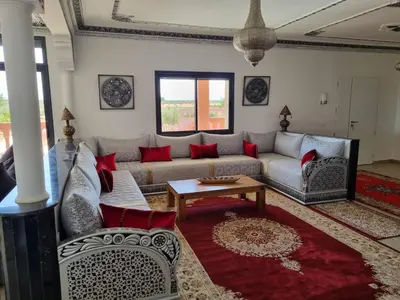 a living room with a couch and a table at Villa des Oliviers MEKNES in Meknès