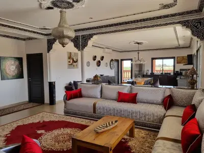 a living room with a couch and a table at Villa des Oliviers MEKNES in Meknès