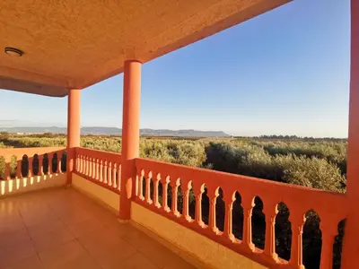 a balcony of a house with a view of the desert at Villa des Oliviers MEKNES in Meknès