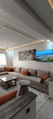 a living room with a couch and a table at APPART-HOTEL La MAISON ATTAWBA 3 in Beni Mellal