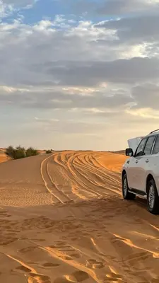 a white car parked in the desert at Ecolodge Le désert in Kasr Bounou