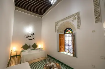 a bedroom with a bed and a window in a room at Riad Nashira in Fès