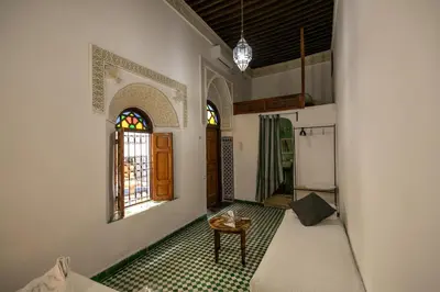 an empty room with a table and a window at Riad Nashira in Fès