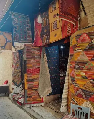 a store with many different types of carpets on display at Nabiloc Apart Hotel - Centre Ville in Fès