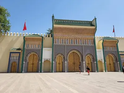 a large building with large doors and a person standing in front at Nabiloc Apart Hotel - Centre Ville in Fès