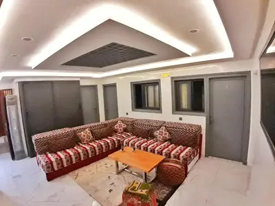 a living room with a couch and a table at Hotel Restaurant Bougafer in Midelt