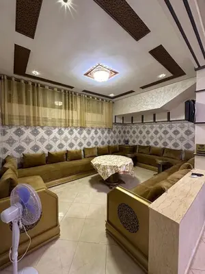 a living room with a couch and a table at Appartement fes magnifique in Fès