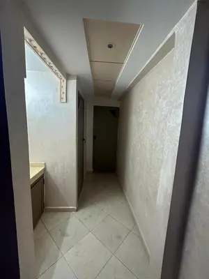 an empty hallway with a door and a tile floor at Appartement fes magnifique in Fès