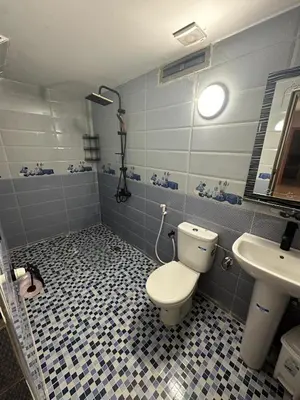 a bathroom with a toilet and a sink at Appartement fes magnifique in Fès