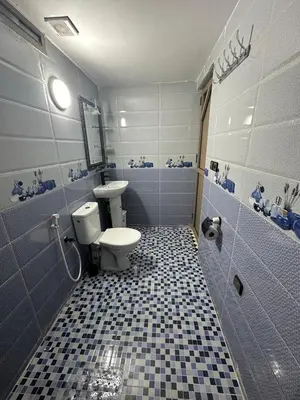 a bathroom with a toilet and a sink at Appartement fes magnifique in Fès