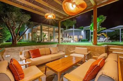 a patio with couches and a table and a house at Villa Bahamas , Luxe et élégance & piscine Chauffée, jacuzzi in Marrakech
