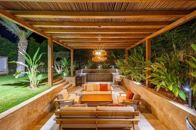 an outdoor patio with couches and chairs and plants at Villa Bahamas , Luxe et élégance & piscine Chauffée, jacuzzi in Marrakech
