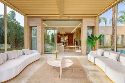 a living room with white couches and a table at Villa Bahamas , Luxe et élégance & piscine Chauffée, jacuzzi in Marrakech