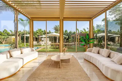 a large living room with white furniture and large windows at Villa Bahamas , Luxe et élégance & piscine Chauffée, jacuzzi in Marrakech