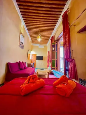 a living room with two beds and a couch at RIAD LALJ Fes in Fès