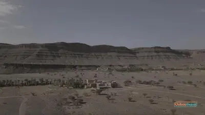 a view of a desert with mountains in the background at Ouboumalne in Tamsahelt