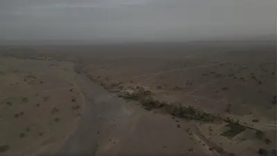 an aerial view of a dirt road in the desert at Ouboumalne in Tamsahelt