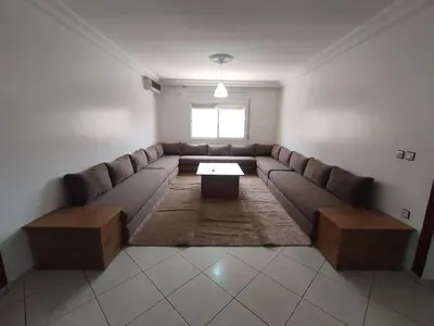 a living room with a large couch and a table at Appartement Moderne 3 Chambres in Khemisset