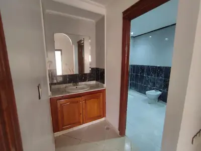 a bathroom with a sink and a mirror and a toilet at Appartement Moderne 3 Chambres in Khemisset