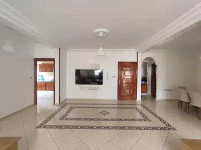 a living room with a tv on a white wall at Appartement Moderne 3 Chambres in Khemisset