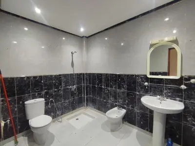 a bathroom with a toilet and a sink at Appartement Moderne 3 Chambres in Khemisset
