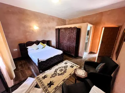 a bedroom with a bed and a living room with a couch at Benyakoub in Mahirija