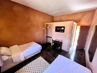 a bedroom with a bed and a clock on the wall at Benyakoub in Mahirija