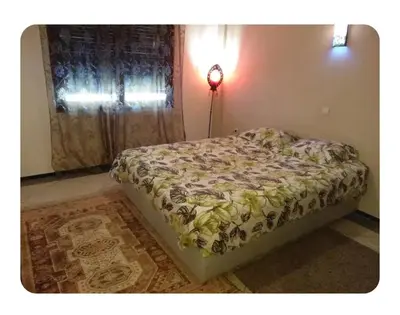 a bed sitting in a bedroom with a window at Apartment Hamria Central in Meknès