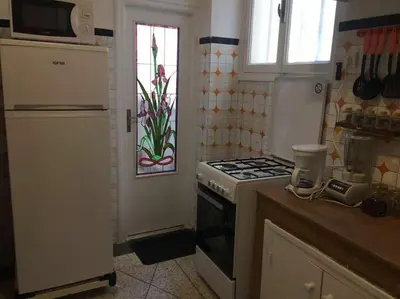 a kitchen with a stove and a window at Apartment Hamria Central in Meknès