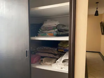 a closet filled with lots of clothes and towels at Apartment Hamria Central in Meknès