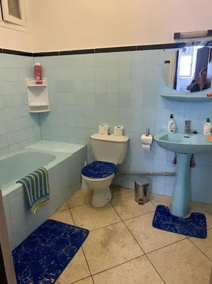 a bathroom with a tub and a toilet and a sink at Apartment Hamria Central in Meknès