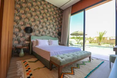 a bedroom with a bed and a large window at Villa Rubis in Marrakech