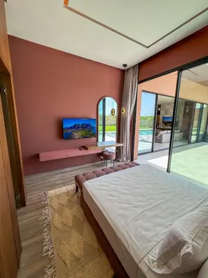 a bedroom with a large bed and a large window at Villa Rubis in Marrakech