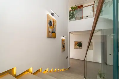 a staircase in a house with paintings on the wall at Villa vue atlas marrakech in Marrakech